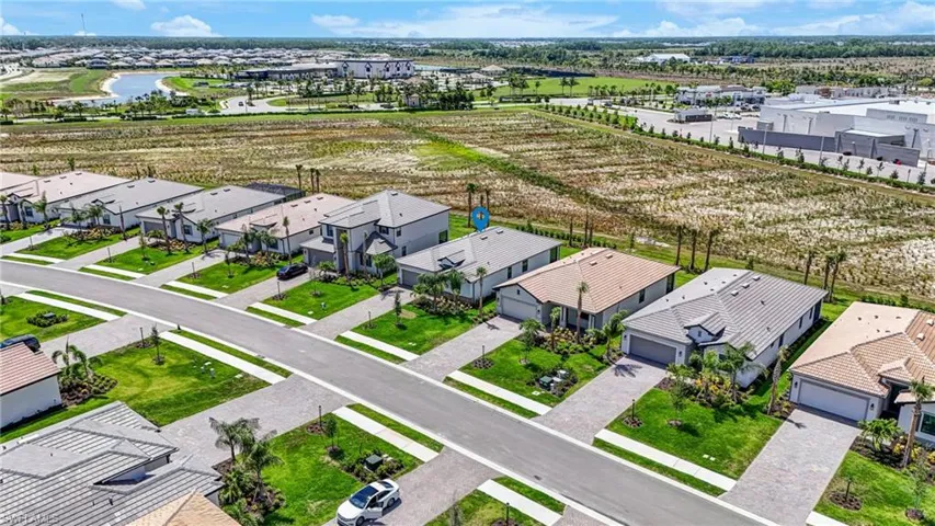Aerial perspective of suburban area featuring a large body of water