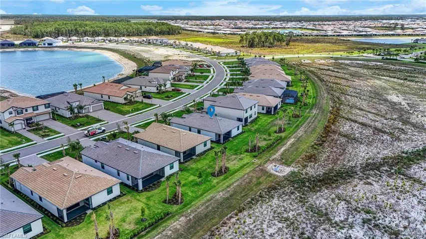 Aerial perspective of suburban area featuring a large body of water