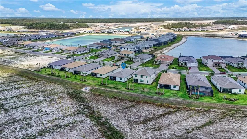 Aerial view of residential area featuring a large body of water