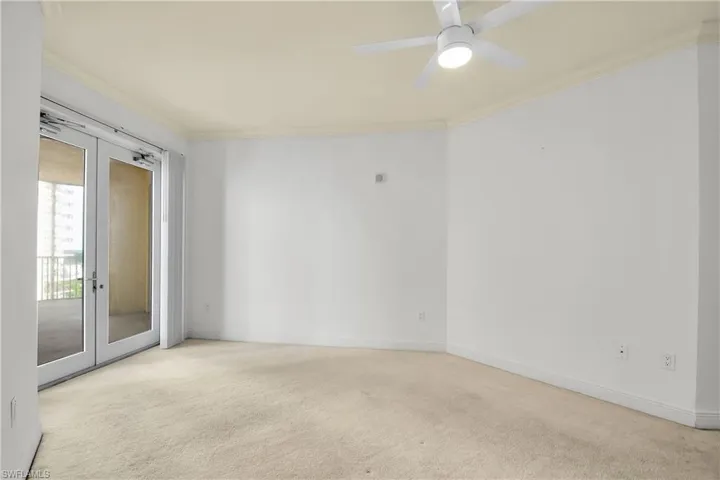 Spare room with ornamental molding, light colored carpet, french doors, and ceiling fan