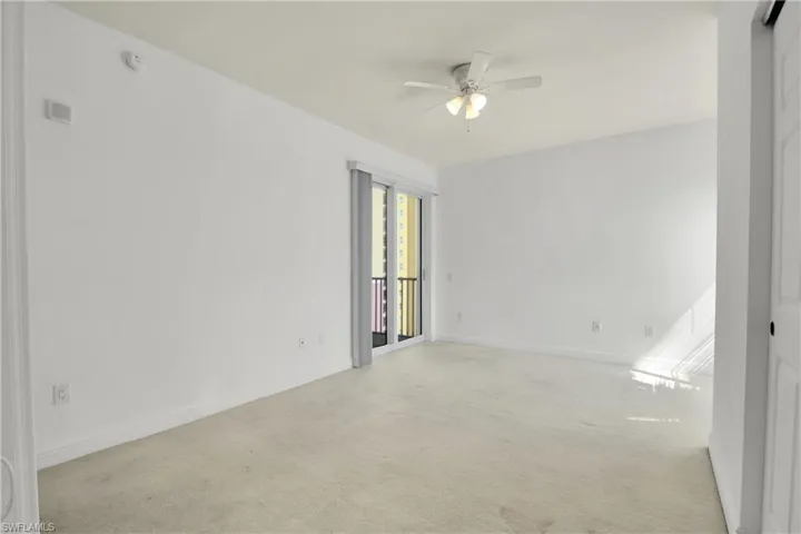 Spare room with light colored carpet and a ceiling fan