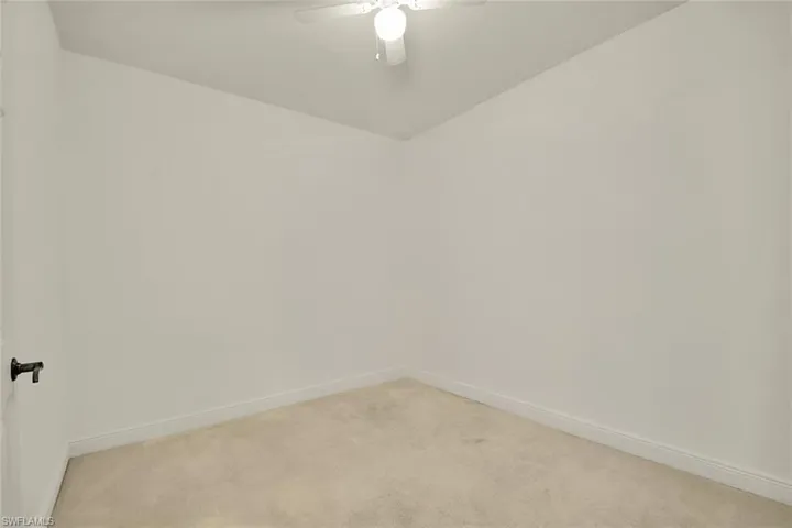 Empty room with carpet and ceiling fan