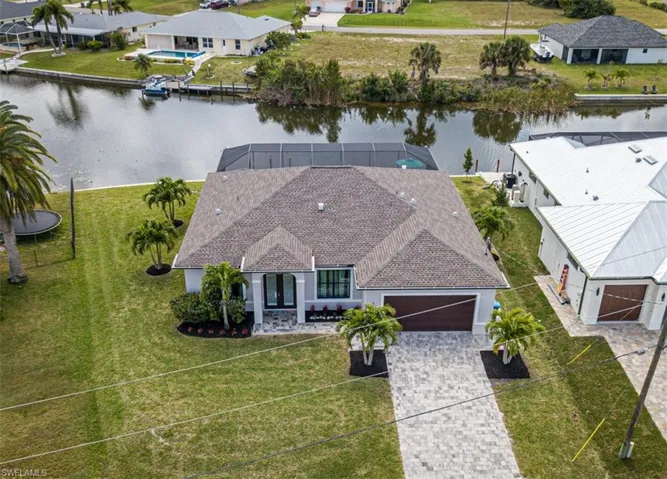 BEAUTIFUL AERIAL VIEW OF FRONT OF HOME AND REAR WATER FRONTAGE