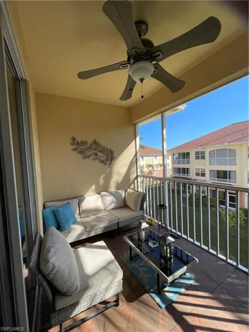 Balcony with ceiling fan and an outdoor living space