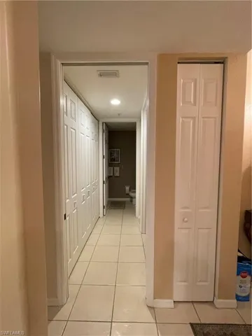 Hallway featuring light tile patterned floors