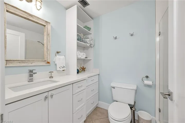Bathroom with tile patterned floors, vanity, and toilet
