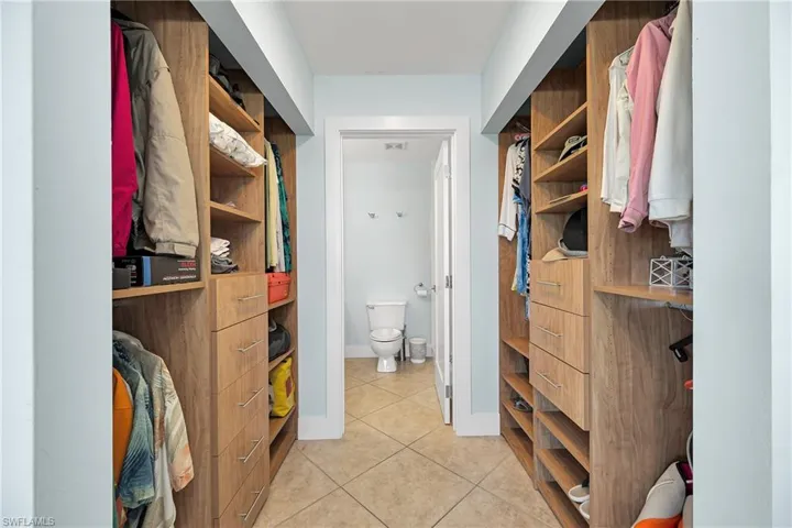 Spacious closet featuring light tile patterned flooring