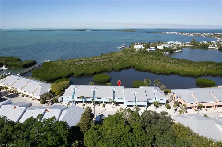 Birds eye view of property with a water view