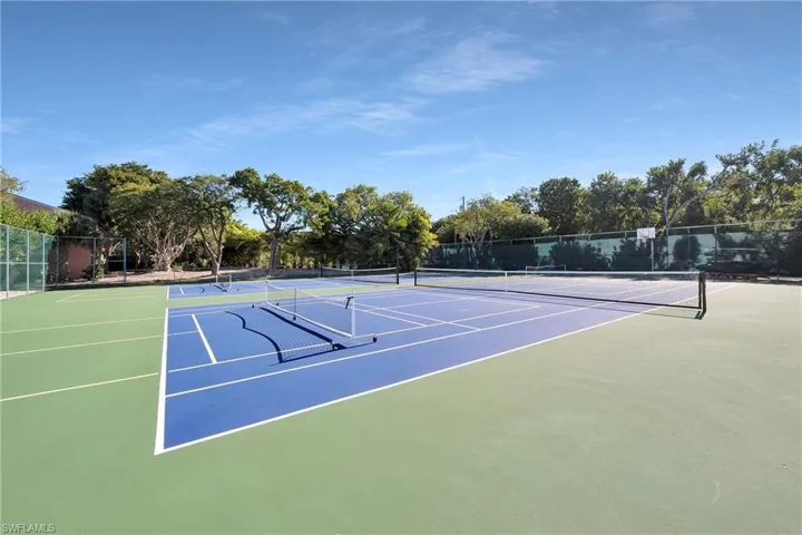 View of tennis court featuring basketball court