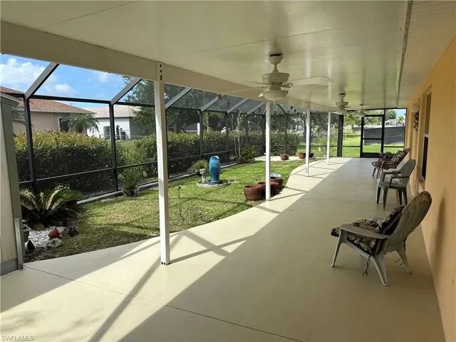 View of patio / terrace featuring a ceiling fan and a lanai