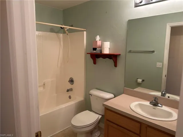Full bath with toilet, vanity, and  shower combination