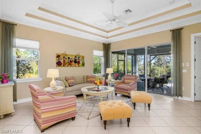 Great room with two windows, adjoining lanai, pool.