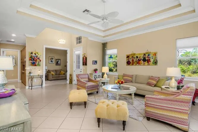 Another angle of the great room with a ceiling fan, this one looking at the main entry, and Den.
