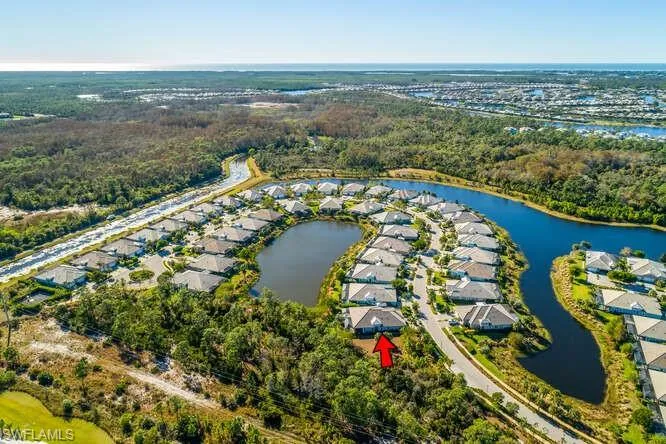 Another Aerial view shows lot location, water, trees.