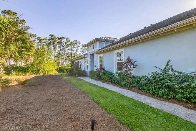 Entry sidewalk, lots of green space, no neighbors on this side. Perfect for someone with a dog.