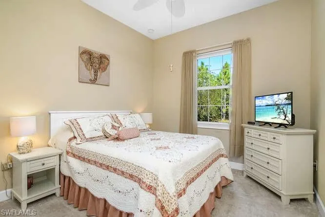 Guest Bedroom featuring a ceiling fan and light colored carpet