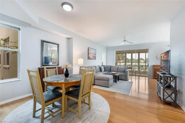 Dining space with ceiling fan and light hardwood / wood-style flooring