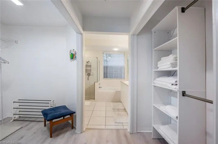 Bathroom featuring separate shower and tub and hardwood / wood-style flooring