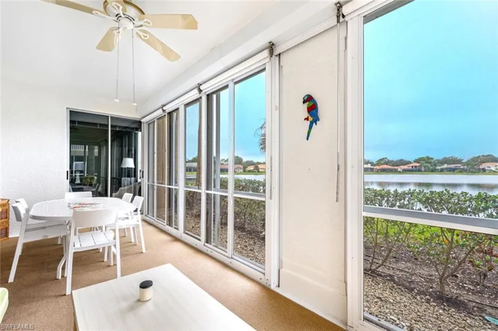 Sunroom featuring a water view and ceiling fan