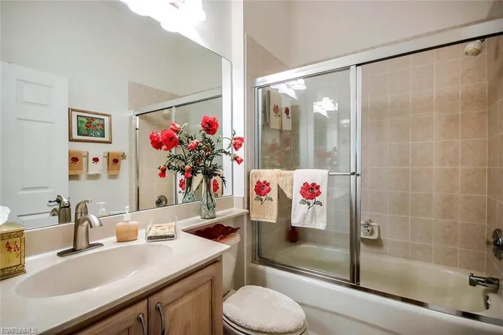 Bathroom with vanity and shower / bath combination with glass door
