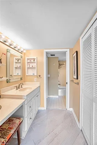Full bathroom with vanity, a closet, and shower / bath combination