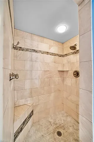 Full bathroom featuring a tile shower