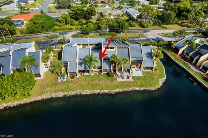 Aerial perspective of suburban area with a nearby body of water