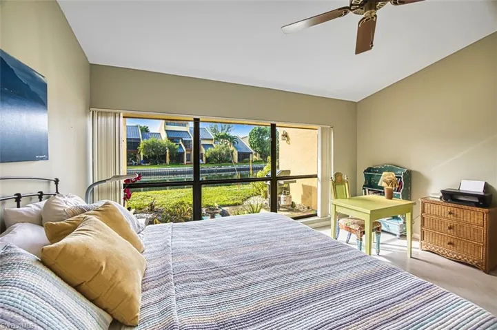 Bedroom with multiple windows and a ceiling fan