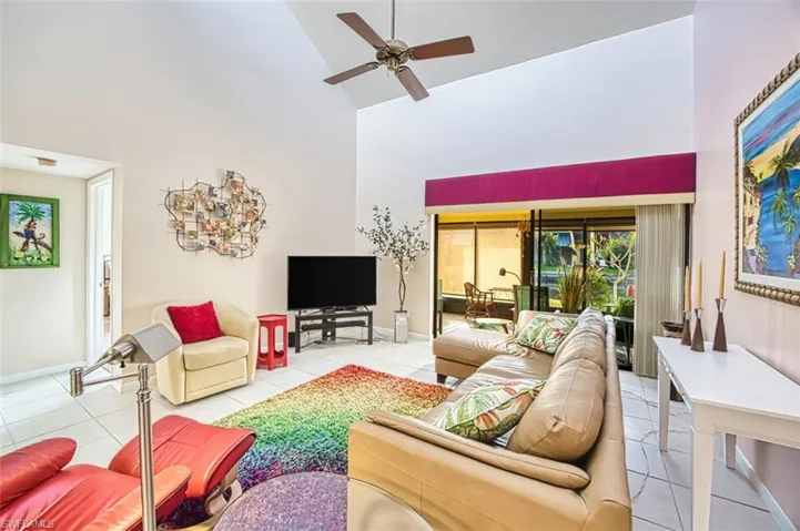 Tiled living area with high vaulted ceiling and ceiling fan