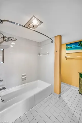 Full bath featuring shower / washtub combination and light tile patterned flooring