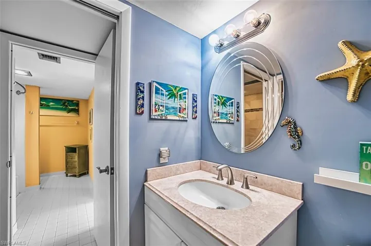 Bathroom with vanity, tile patterned floors, and a shower with shower curtain