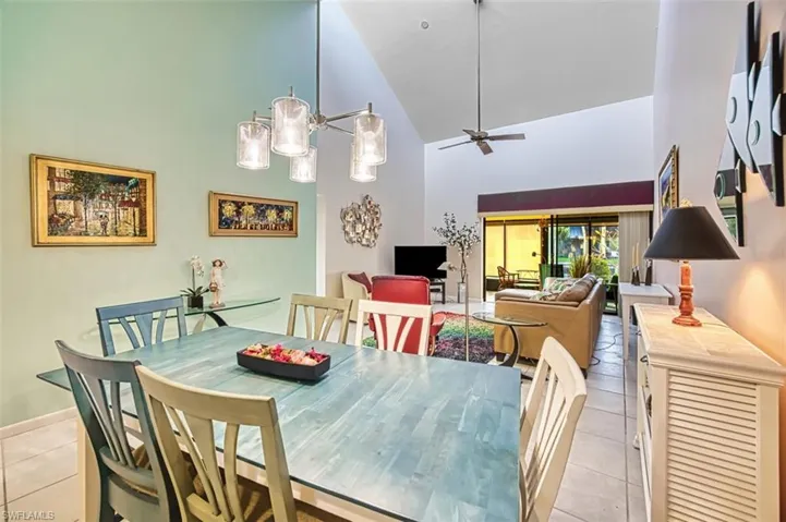 Dining room featuring high vaulted ceiling and a ceiling fan