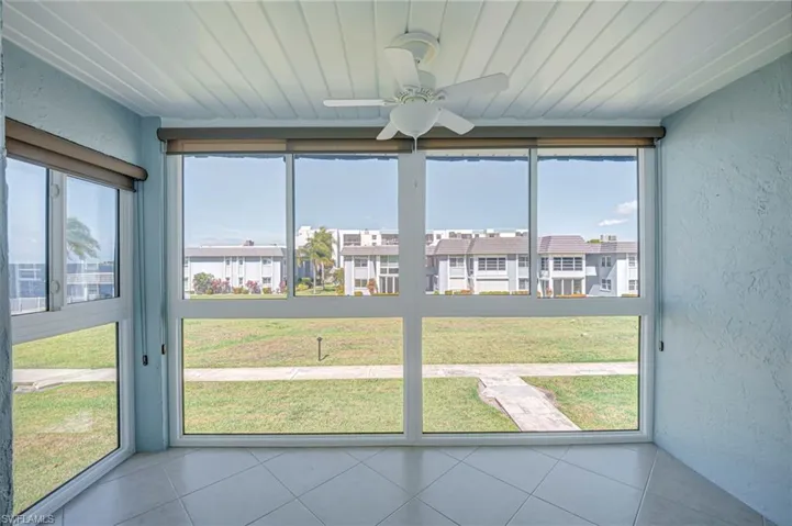 Enclosed lanai with Impact Resistant Windows!  Decorative Ceiling!  Tile flooring has been continued!  Sidewalks from Building to Amenity Center!