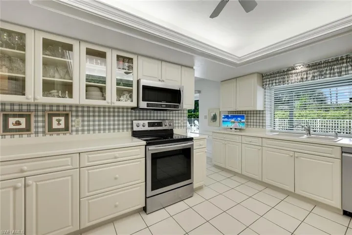 Prepare meals while enjoying pool views.