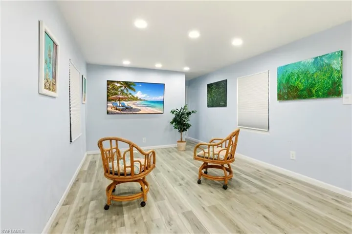 Living area featuring light wood-style flooring and recessed lighting