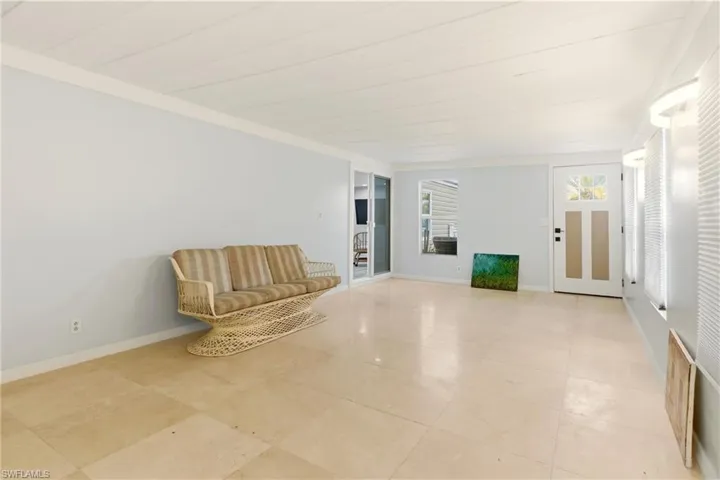 Unfurnished room featuring wood ceiling and crown molding