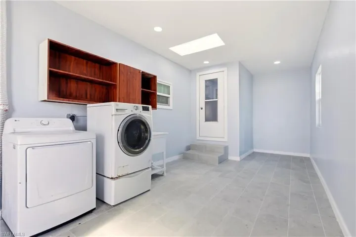 Laundry area featuring separate washer and dryer, a skylight, and recessed lighting