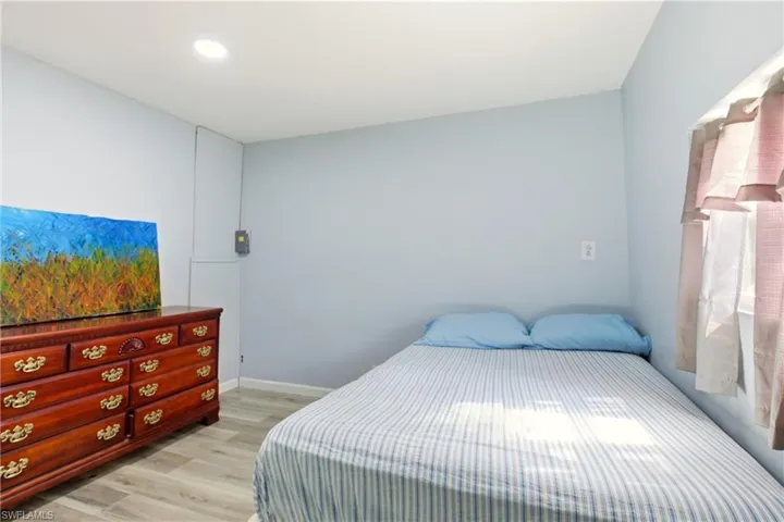 Bedroom with light wood-type flooring and recessed lighting