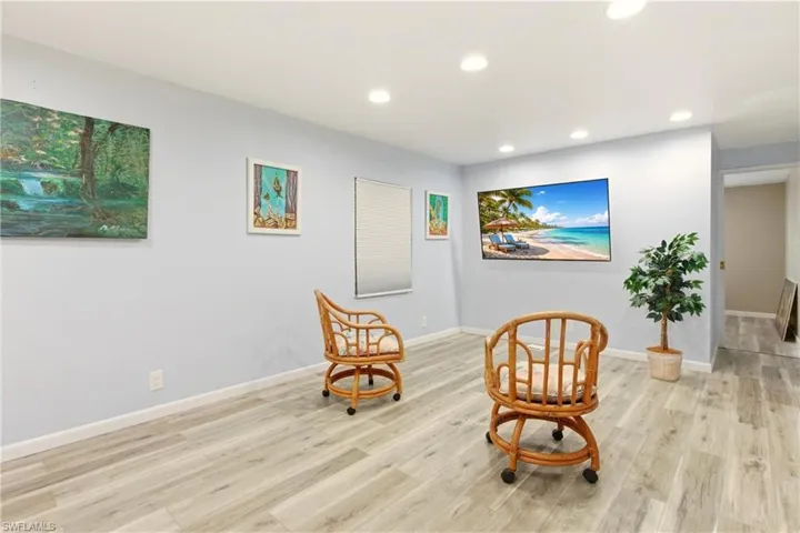 Sitting room featuring light wood-style flooring and recessed lighting