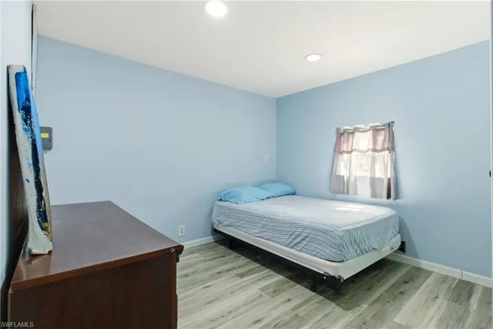 Bedroom with light wood-style floors and recessed lighting