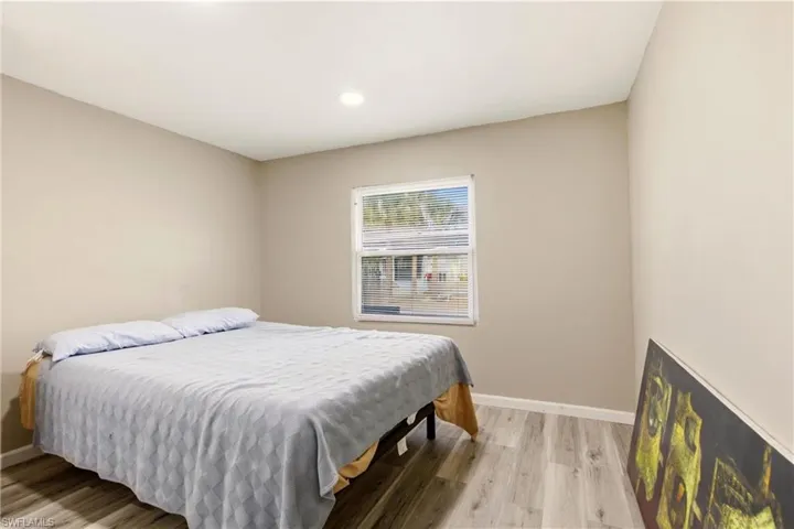 Bedroom with light wood finished floors and recessed lighting