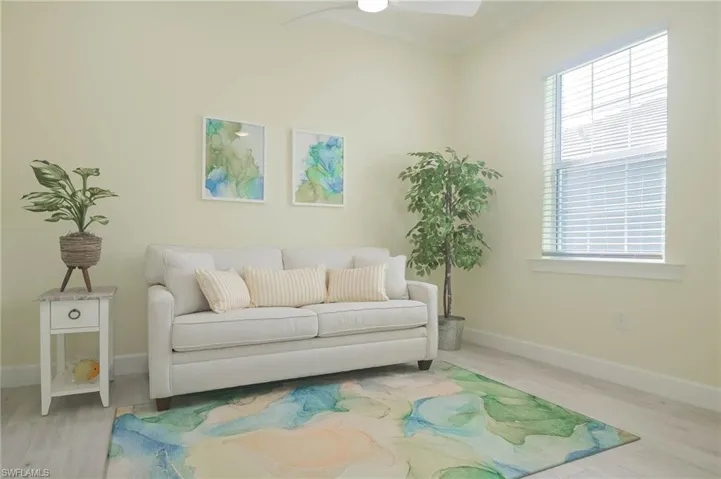 Living room featuring ceiling fan and light wood-type flooring
