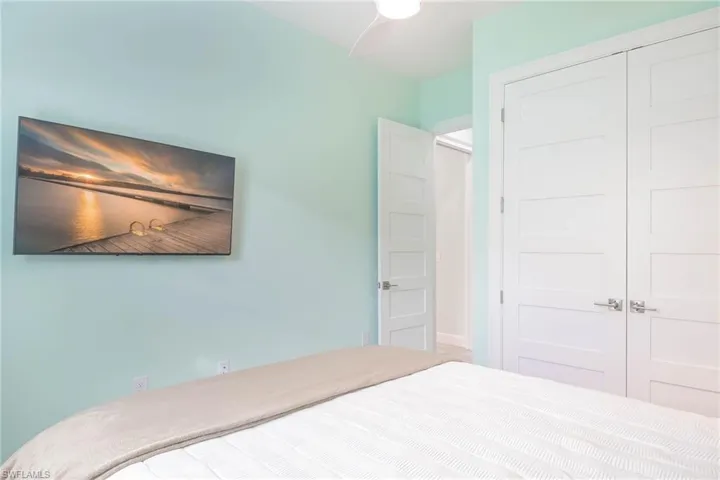 Bedroom with ceiling fan and a closet