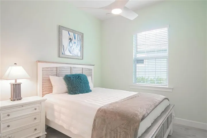 Bedroom with ceiling fan and light hardwood / wood-style floors