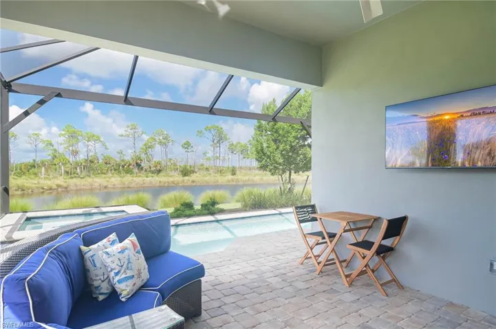View of patio / terrace with a water view and glass enclosure