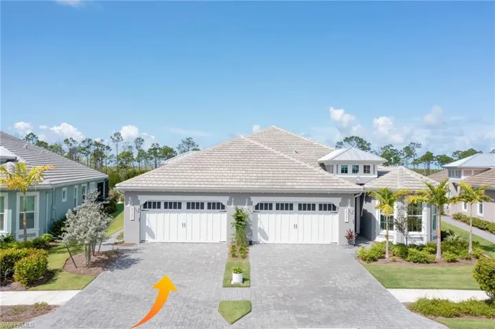View of front of house with a garage and a front lawn