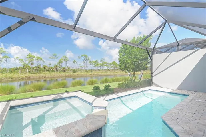 View of pool featuring a lanai and a water view