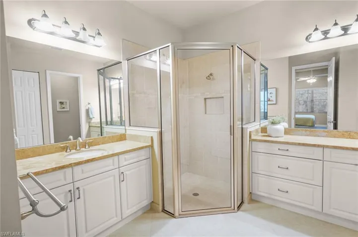 Ensuite bathroom featuring vanity and a shower stall