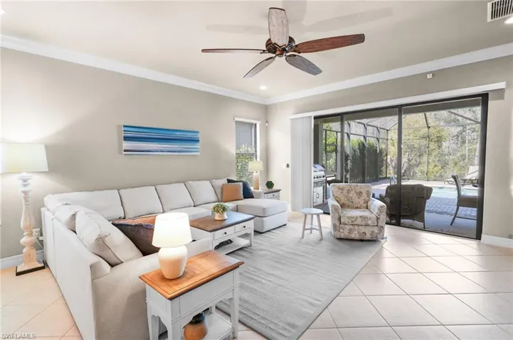 Living area with crown molding, light tile patterned flooring, recessed lighting, a ceiling fan, and a sunroom