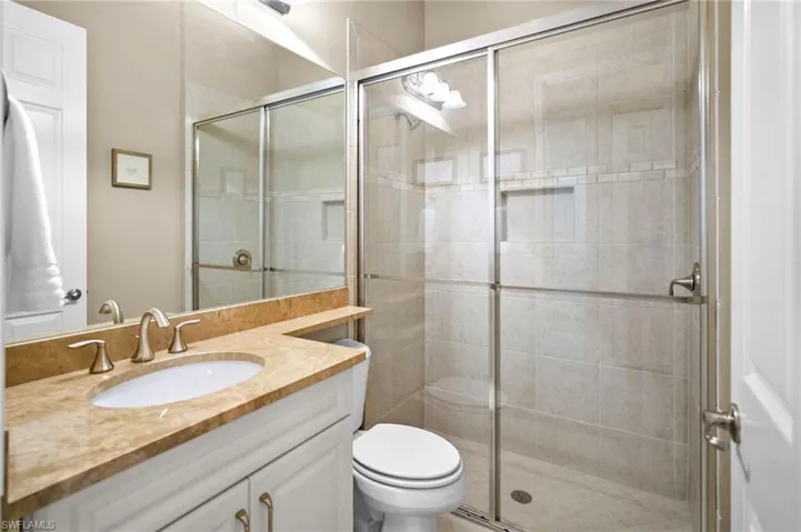 Bathroom with vanity and a shower stall